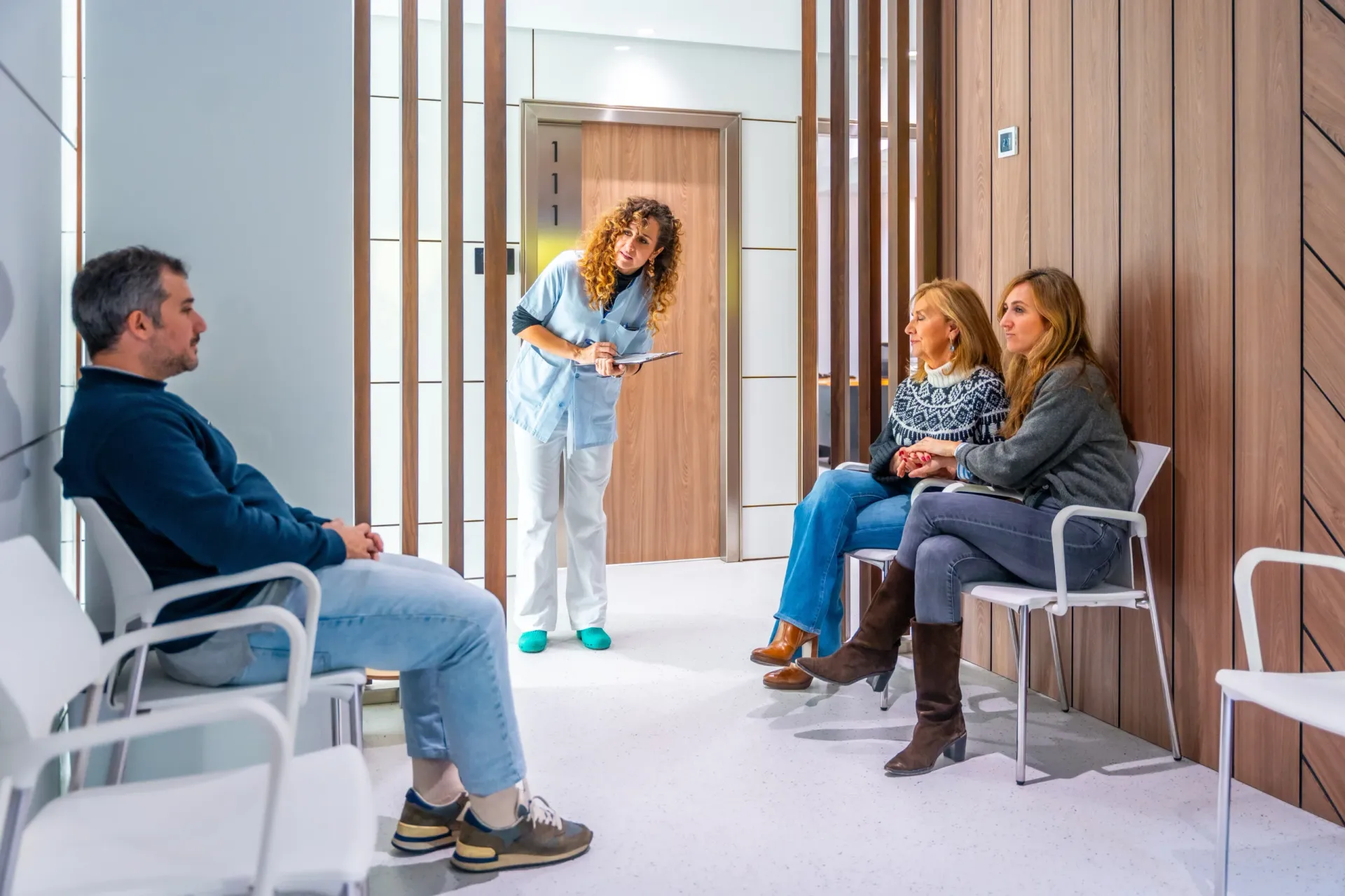 Patients waiting to be seen as a nurse greets them in the Eastgardens Medical Centre waiting area